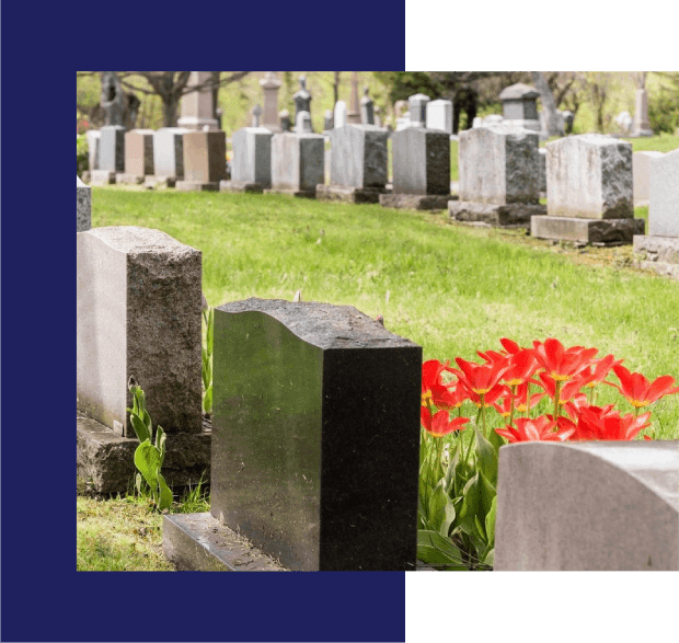 A cemetery with many headstones and flowers.