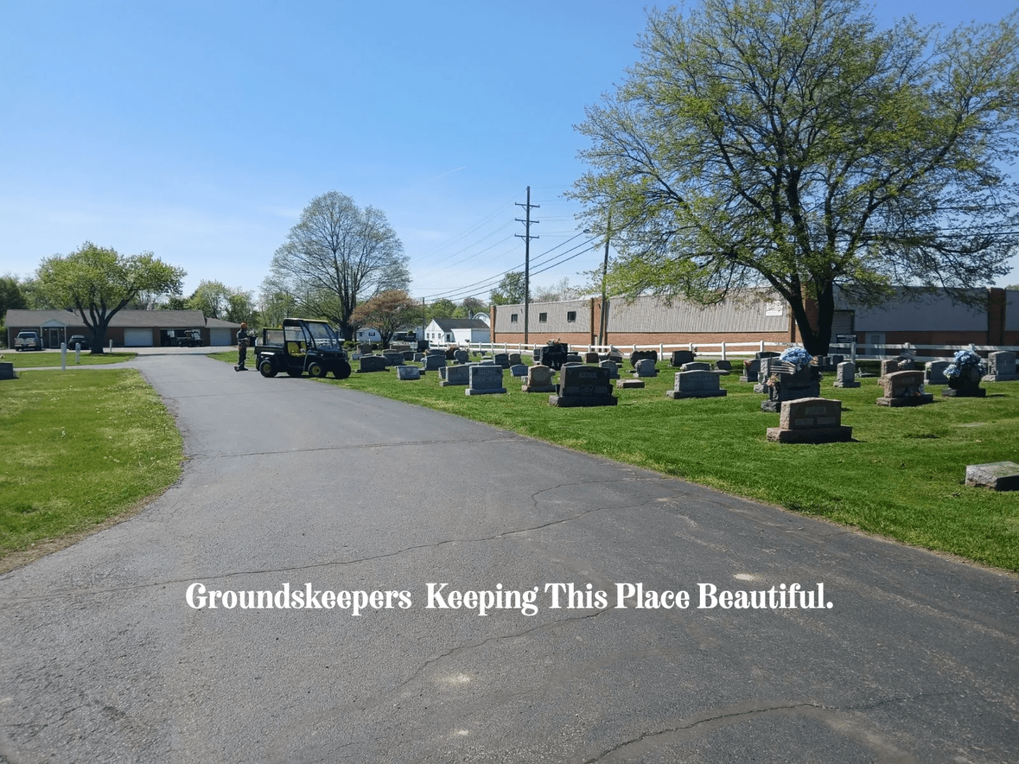 A cemetery with many tombstones and trees.